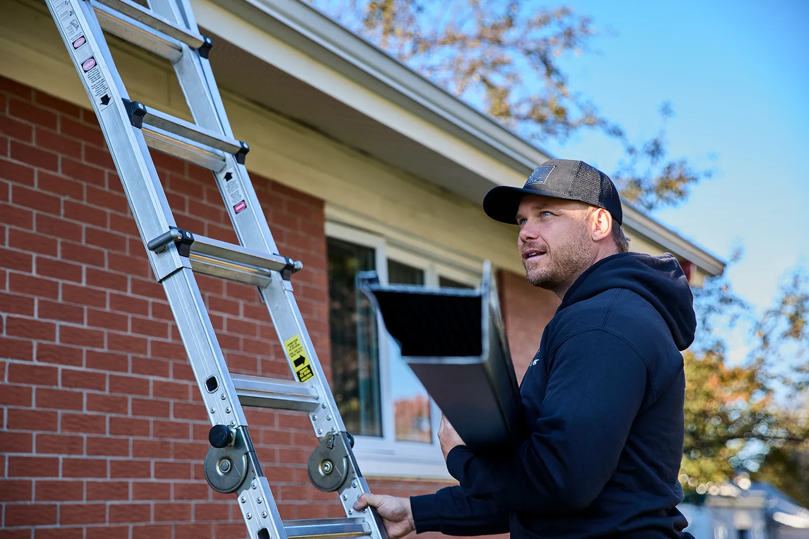 Downspout installation on a two-storey home — Canadian Eavestrough, Edson AB